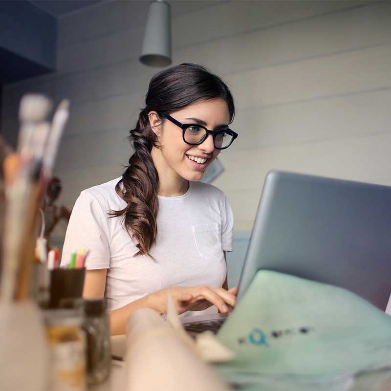 Professional female day trader working on her laptop